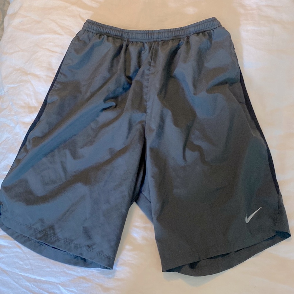 Nike running shorts. Grey with black trim. Side pockets. Small pocket inside.